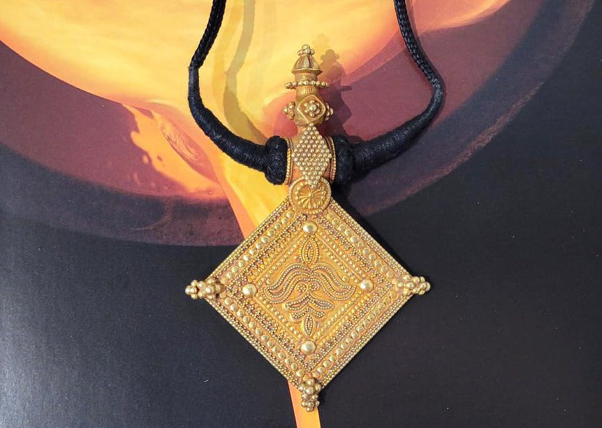 18K Y/G Matte Gold Indian Pendant Attached to a Black Cord
